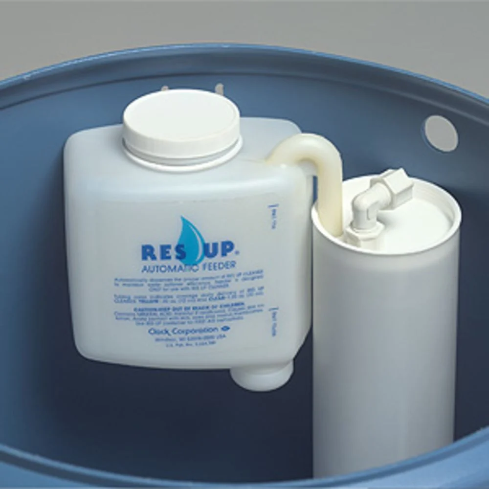 Res-Up feeder mounted inside a brine tank beside the brine well, feed tube running through the well cap
